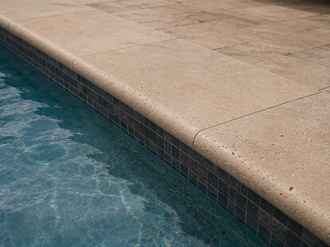 Travertine edge paver for pool perimeter