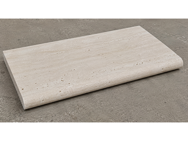 Natural travertine pool coping around outdoor swimming pool